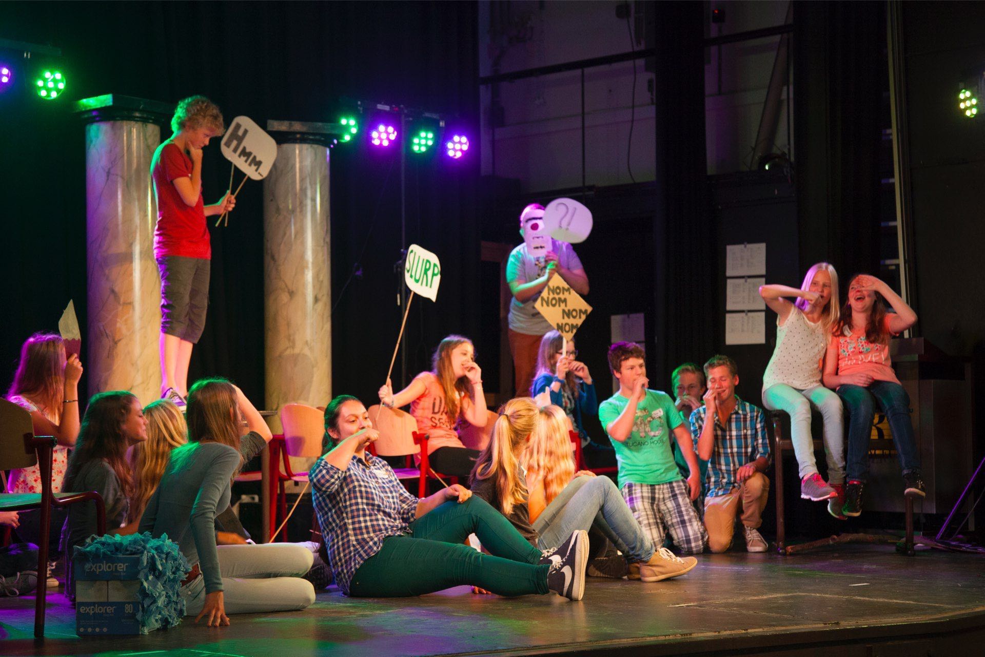 Leerlingen werken in een gymzaal aan een dansworkshop van TheaterChallenge